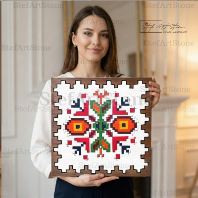 Жена държи ръчно рисувана многоцветна картина Елбетица